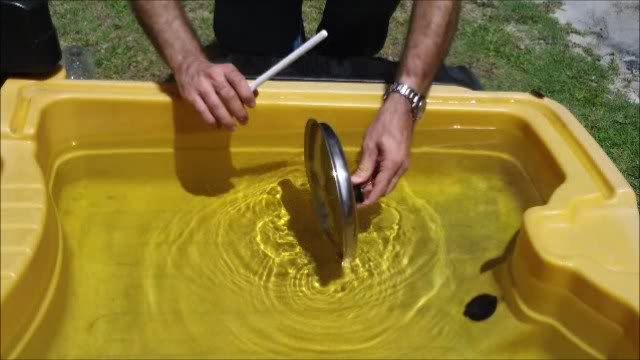 Dipping a pot lid in water for music Dipping a pot lid in water for music